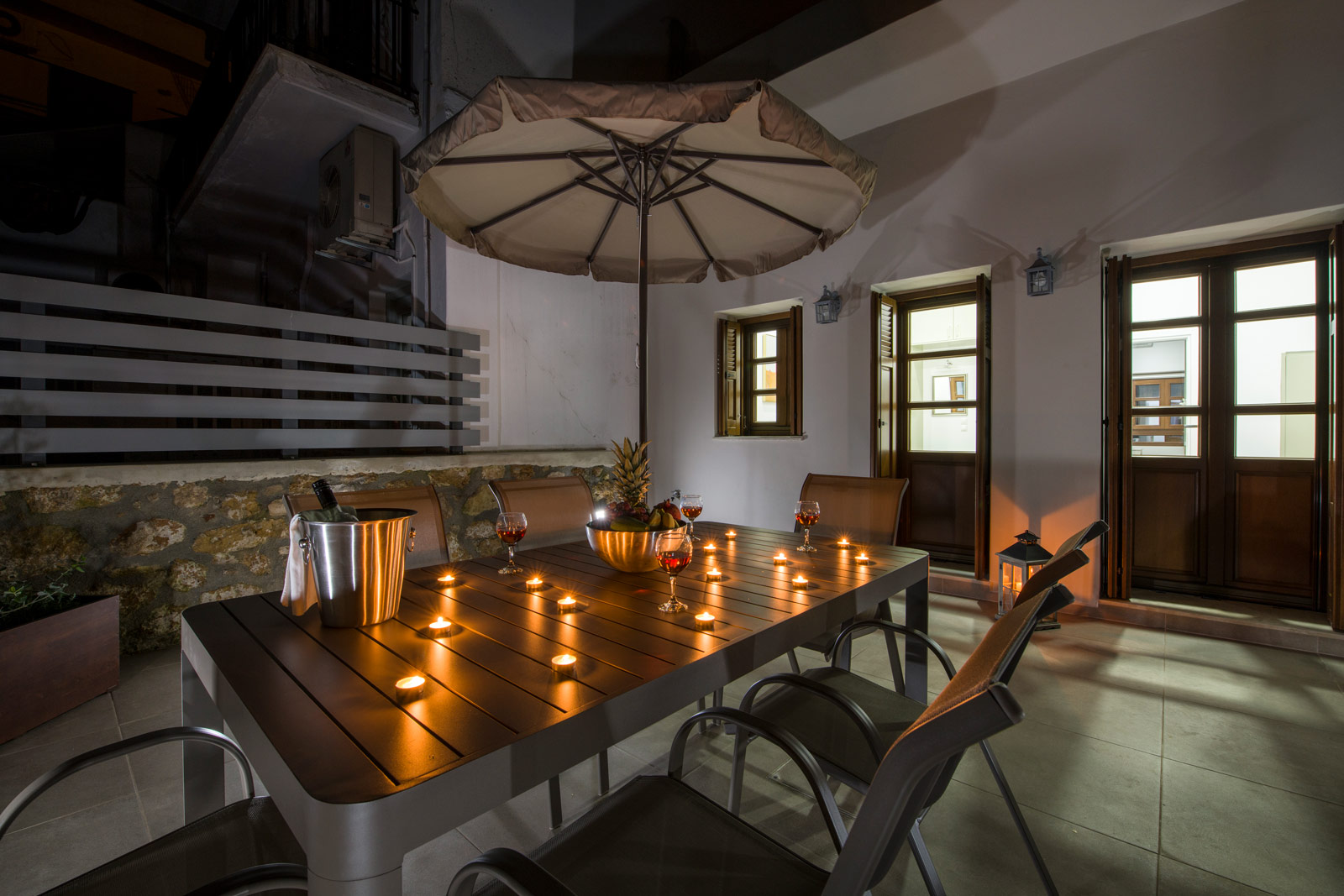 Hotel's balcony at night with wine served at table